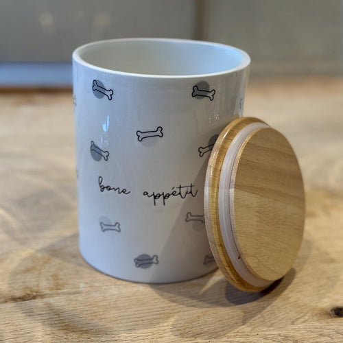 Dog treat jar with "bone Appetit" written across it with black and white bone outlines 