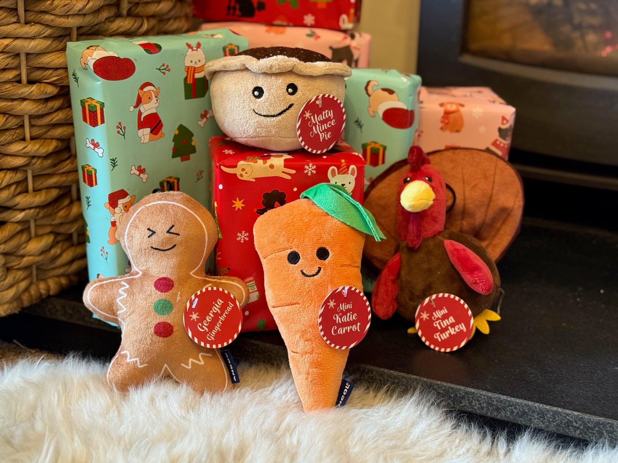 Set of plush toys shaped like a gingerbread man, carrot, and turkey on a surface with a wicker basket in the background.