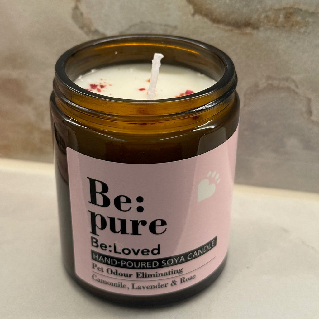 candle with rose petals on top in bathroom